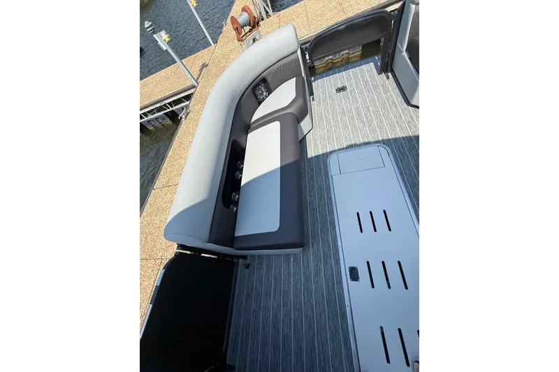 Slide: The Image of 2027 Premier 250 Sunsation boat interior with gray seating and striped flooring. - 8