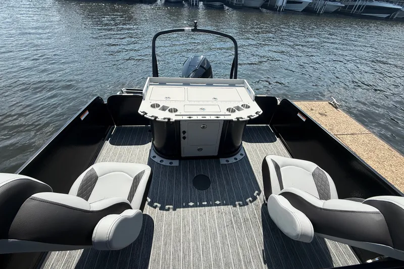 Slide: The Image of 2027 Premier 250 Sunsation boat interior with modern seating and control panel on water. - 9
