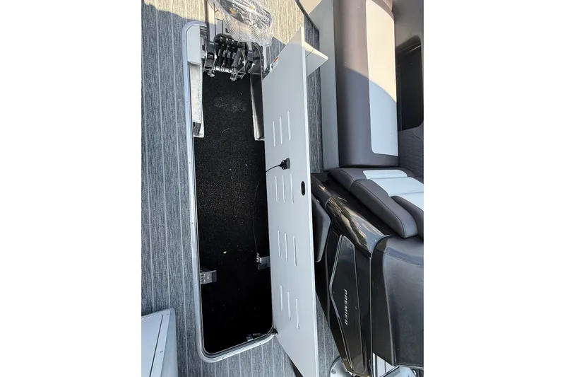 Slide: The Image of Open storage compartment on 2027 Premier 250 Sunsation boat with sleek seating. - 13