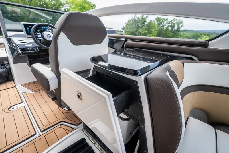 Slide: The Image of 2023 Yamaha Boats 275SE interior with sleek seating and modern dashboard design. - 33