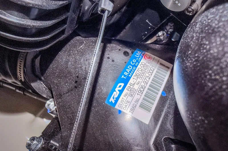 Slide: The Image of Close-up of a 2023 Yamaha Boats 275SE engine component with a T.RAD Co., Ltd. label. - 39