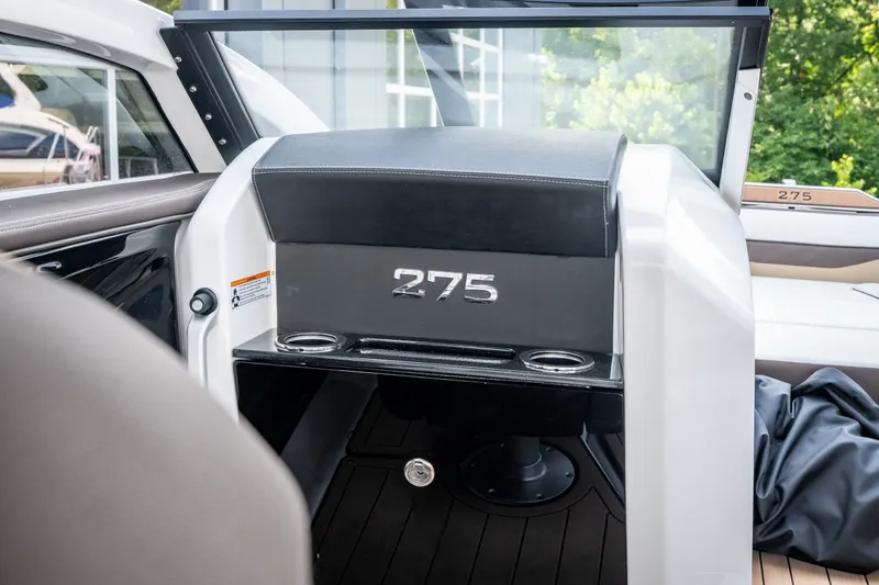 Slide: The Image of 2023 Yamaha Boats 275SE interior with sleek design and cup holders. - 12