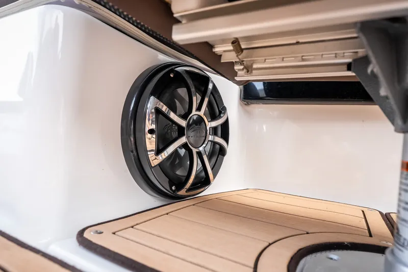 Slide: The Image of 2023 Yamaha Boats 275SE interior speaker detail with sleek design and wood finish. - 30