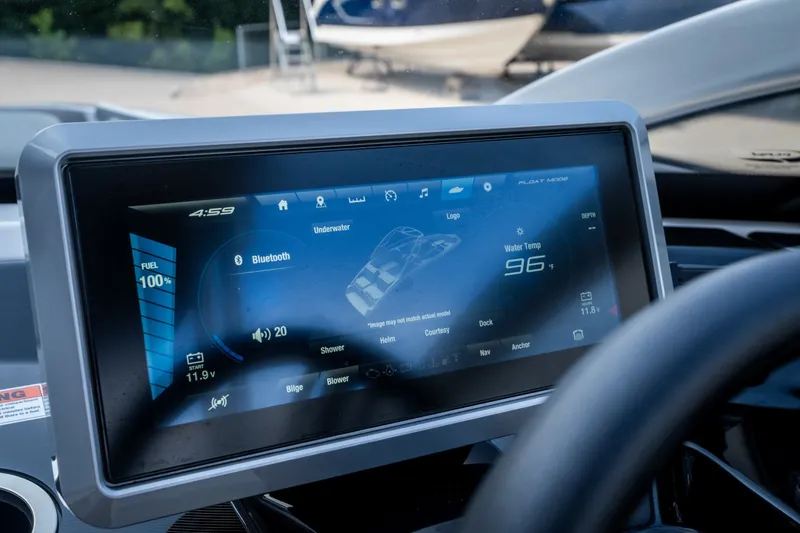 Slide: The Image of 2023 Yamaha Boats 275SE dashboard display showing fuel, Bluetooth, and water temperature. - 16