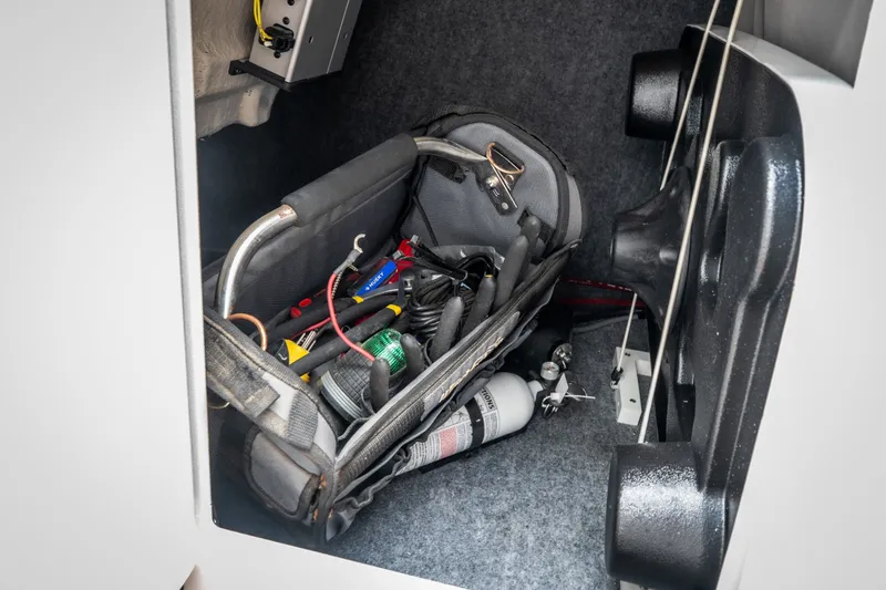 Slide: The Image of Storage compartment of 2023 Yamaha Boats 275SE with tools and equipment. - 38