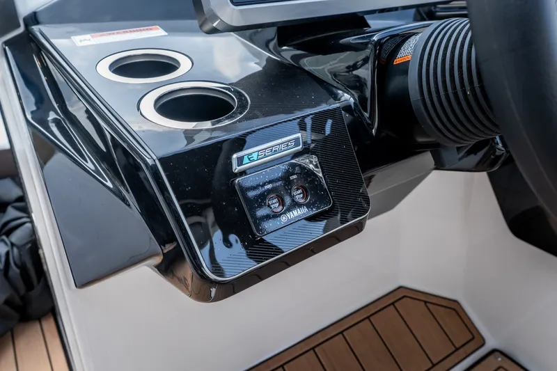 Slide: The Image of 2023 Yamaha Boats 275SE dashboard with cup holders and control panel. - 17