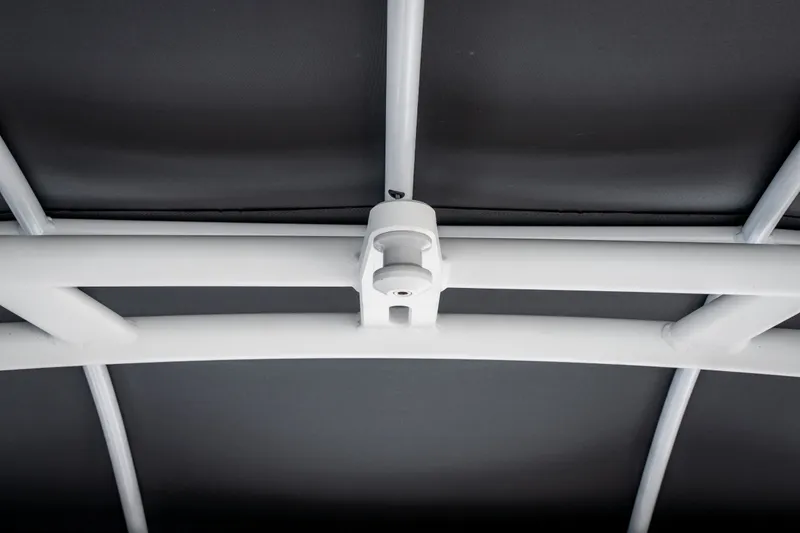 Slide: The Image of 2023 Yamaha Boats 275SE canopy frame detail, showcasing sturdy construction and sleek design. - 29