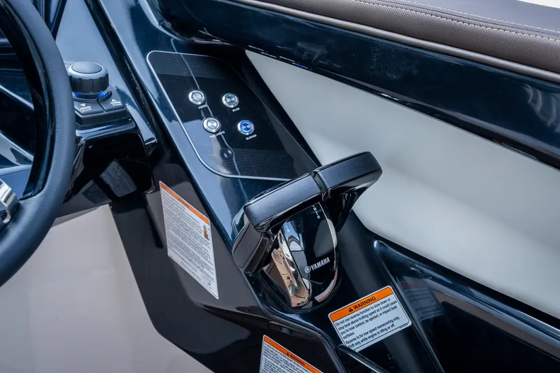 Slide: The Image of Control panel of 2023 Yamaha Boats 275SE with throttle and buttons. - 15