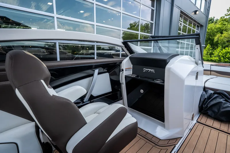 Slide: The Image of 2023 Yamaha Boats 275SE interior with sleek seating and modern dashboard design. - 19