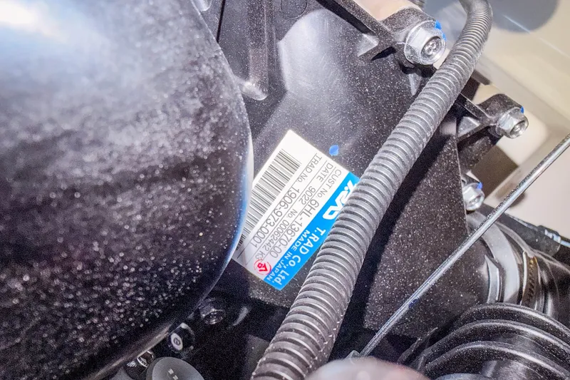 Slide: The Image of Close-up of a 2023 Yamaha Boats 275SE engine component with visible label and wiring. - 40