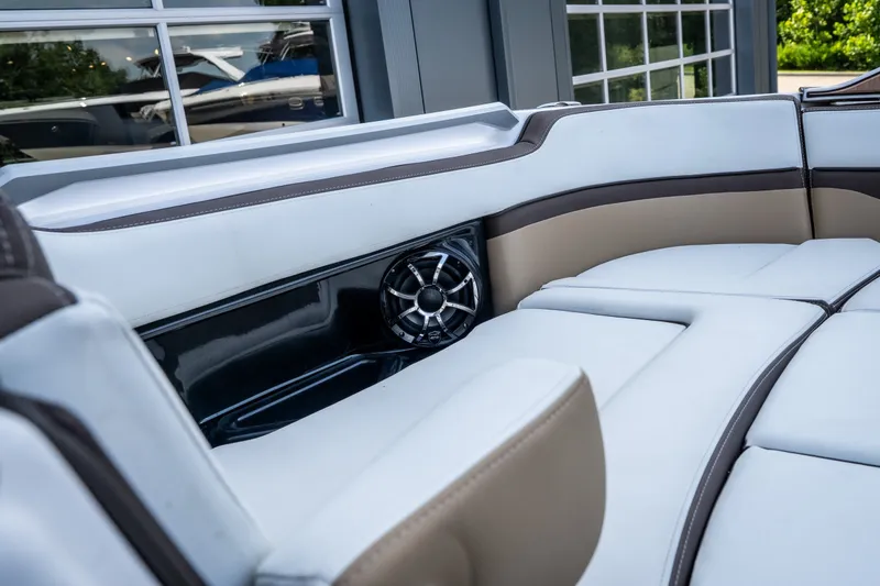 Slide: The Image of 2023 Yamaha Boats 275SE interior with luxurious seating and built-in speaker system. - 22