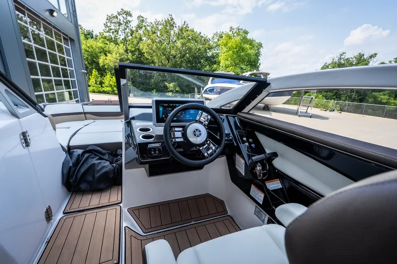 Slide: The Image of 2023 Yamaha Boats 275SE cockpit with modern dashboard and luxurious seating. - 13