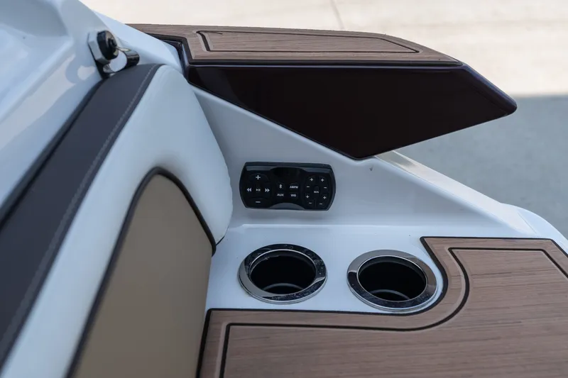 Slide: The Image of 2023 Yamaha Boats 275SE interior with cup holders and control panel. - 7