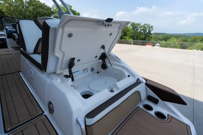 Slide: The Image of 2023 Yamaha Boats 275SE with open storage compartment, showcasing sleek design and functionality. - 6
