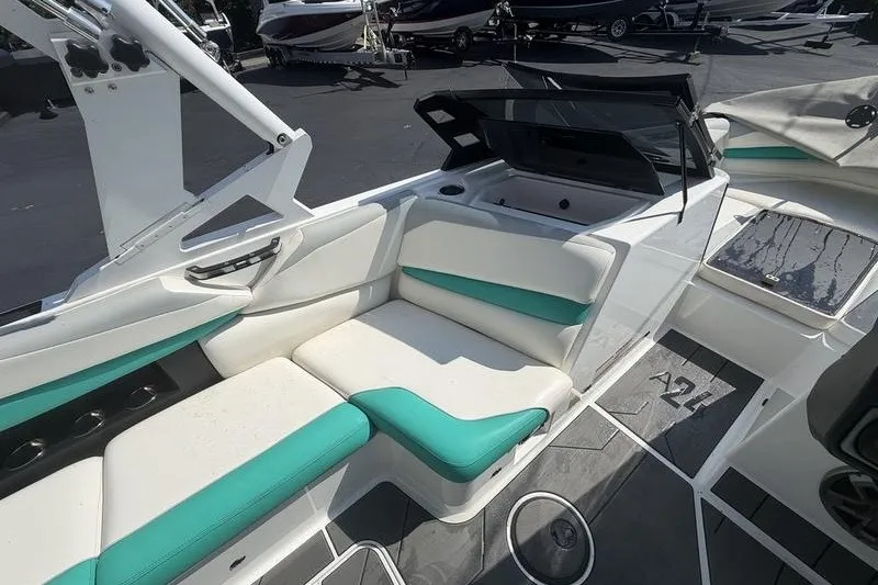 Slide: The Image of 2019 Axis A24 boat interior with white and teal seating, sleek design, and modern features. - 7
