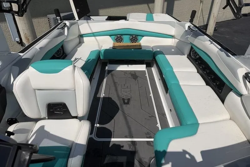 Slide: The Image of 2019 Axis A24 boat interior with teal and white seating, featuring spacious layout. - 6