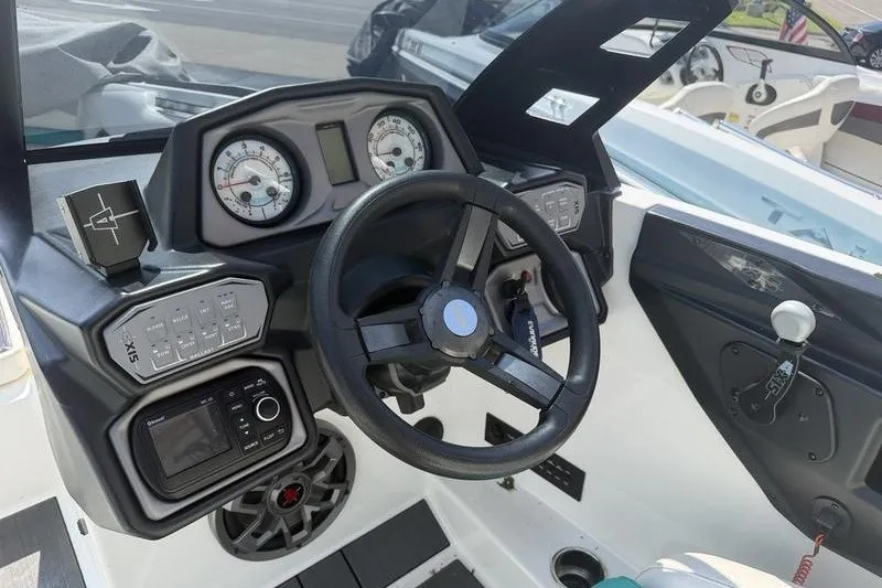 Slide: The Image of 2019 Axis A24 boat dashboard with steering wheel, gauges, and control panel. - 4