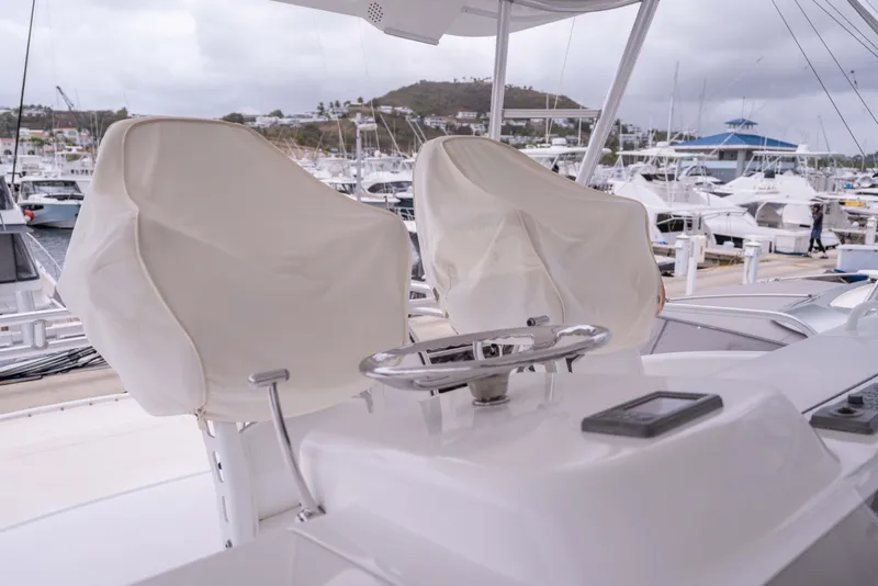 Slide: The Image of Helm of 2005 Viking 56 Convertible yacht with covered seats in marina. - 24