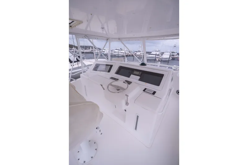 Slide: The Image of Helm of 2005 Viking 56 Convertible yacht with modern navigation equipment. - 23