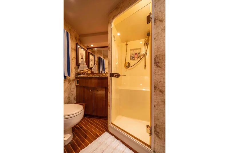 Slide: The Image of Luxurious bathroom in 2005 Viking 56 Convertible yacht with shower, toilet, and wooden flooring. - 16