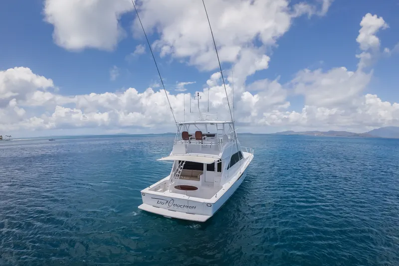Slide: The Image of 2005 Viking 56 Convertible yacht on open sea under blue sky and clouds. - 35
