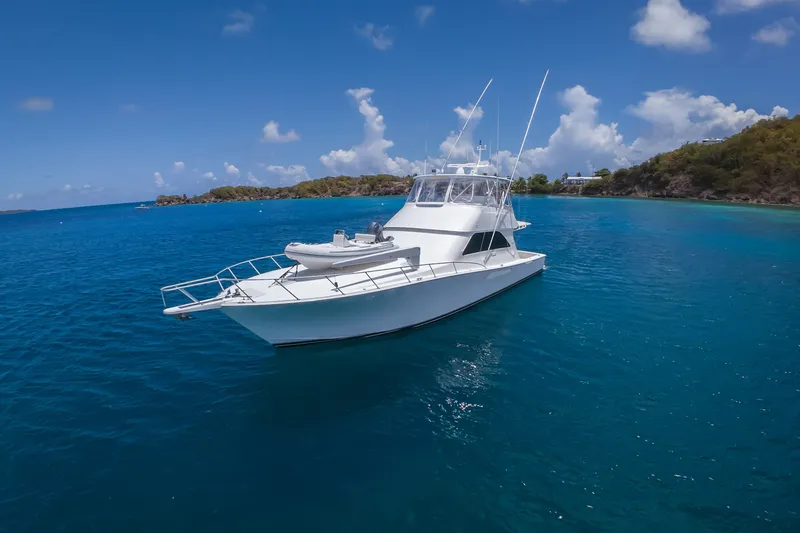 Slide: The Image of 2005 Viking 56 Convertible yacht on clear blue water, under a bright sky. - 36