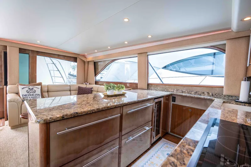 Slide: The Image of Luxurious interior of 2005 Viking 56 Convertible yacht with elegant kitchen and seating area. - 5