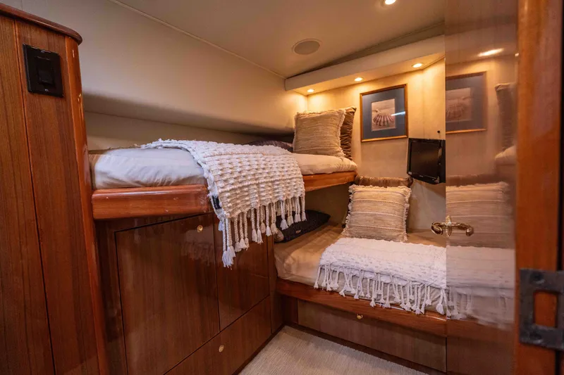 Slide: The Image of Luxurious 2005 Viking 56 Convertible yacht cabin with cozy bunk beds and elegant decor. - 18