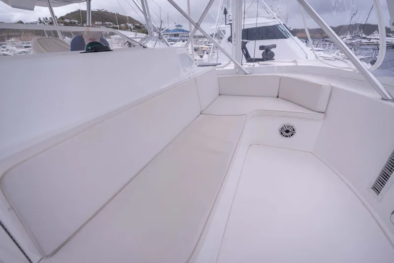 Slide: The Image of Luxurious seating area on a 2005 Viking 56 Convertible yacht, featuring white cushions. - 26