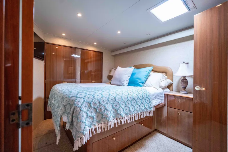 Slide: The Image of Luxurious bedroom interior of 2005 Viking 56 Convertible yacht with cozy bedding and elegant wood finishes. - 13