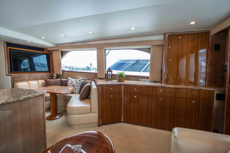 Slide: The Image of Luxurious interior of 2005 Viking 56 Convertible yacht with elegant wood finishes and plush seating. - 10