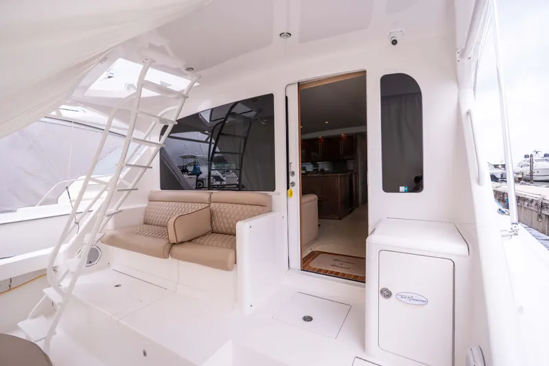 Slide: The Image of 2005 Viking 56 Convertible yacht interior with seating, ladder, and open cabin door. - 22
