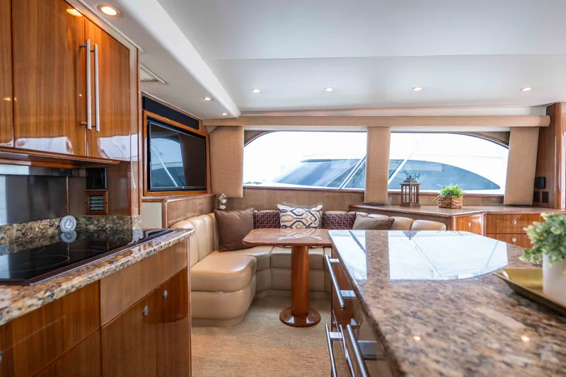 Slide: The Image of Luxurious interior of a 2005 Viking 56 Convertible yacht with elegant wood finishes and plush seating. - 6