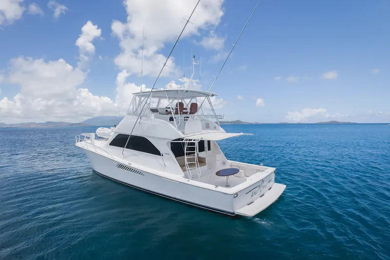 The Image of 2005 Viking 56 Convertible yacht on calm blue ocean under clear sky. - 0