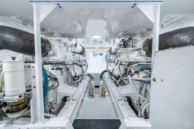 Slide: The Image of Engine room of a 2005 Viking 56 Convertible yacht, showcasing dual engines and mechanical components. - 31