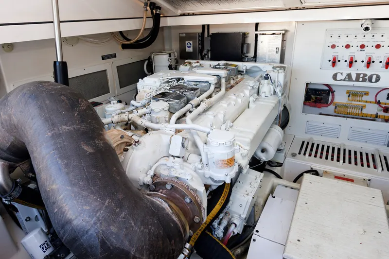 Slide: The Image of Engine room of a 2006 Cabo Yachts 40 Express, showcasing detailed machinery and control panel. - 47