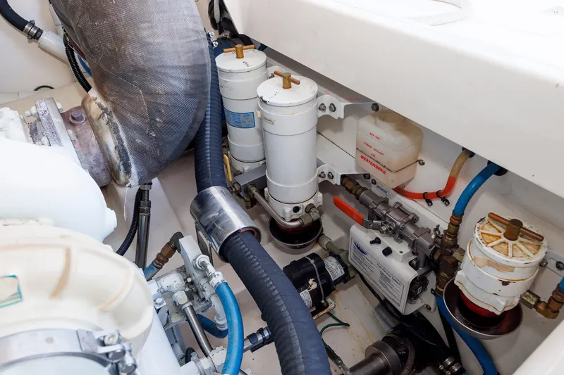 Slide: The Image of Engine room of 2006 Cabo Yachts 40 Express, showcasing mechanical components and filters. - 54