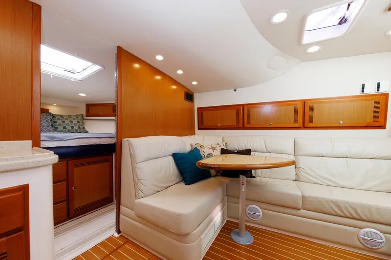 Slide: The Image of Luxurious interior of 2006 Cabo Yachts 40 Express with cozy seating and elegant wood finishes. - 30