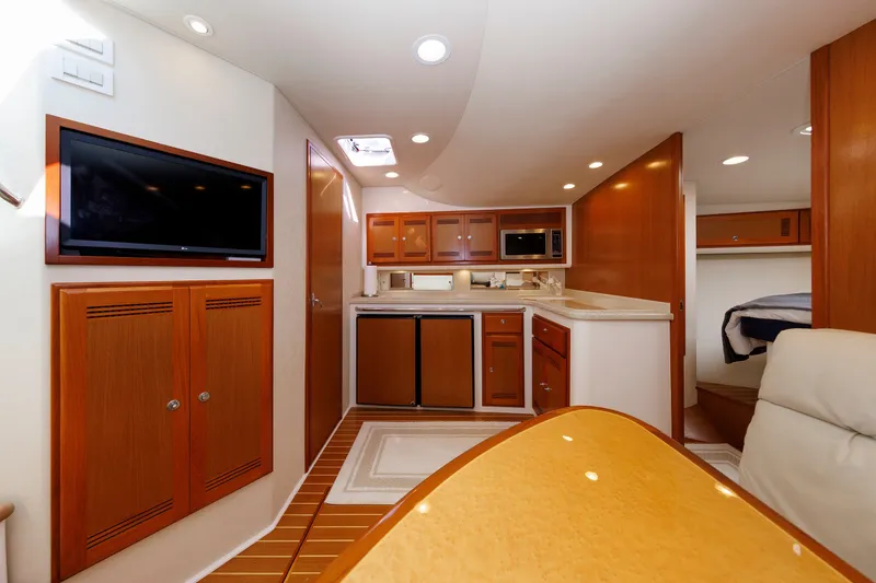 Slide: The Image of Luxurious interior of 2006 Cabo Yachts 40 Express with modern amenities and elegant wood finishes. - 26