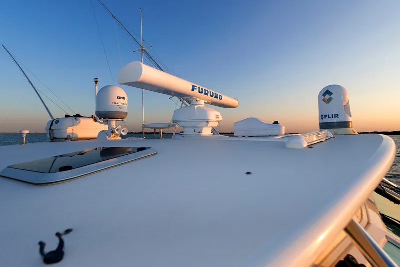 Slide: The Image of 2006 Cabo Yachts 40 Express boat deck with radar and navigation equipment at sunset. - 44