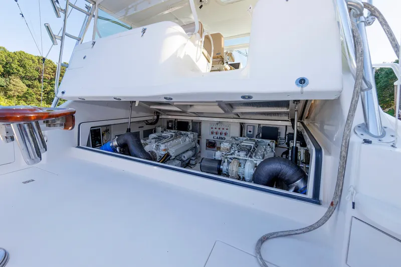 Slide: The Image of Engine compartment of a 2006 Cabo Yachts 40 Express, showcasing dual engines and control systems. - 57