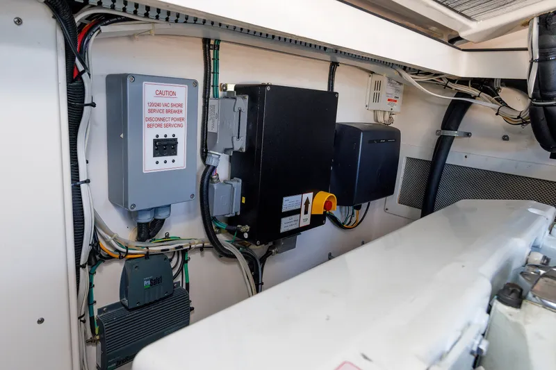 Slide: The Image of Engine room of 2006 Cabo Yachts 40 Express, showcasing electrical systems and wiring. - 53