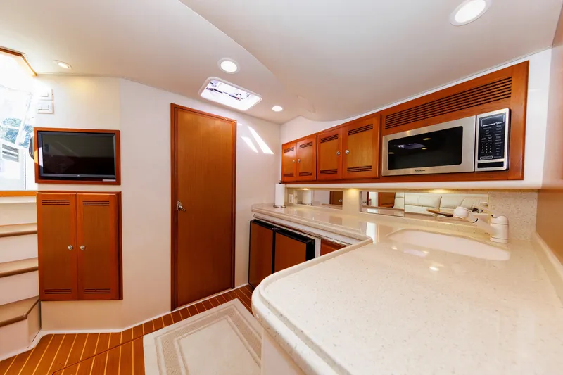 Slide: The Image of Luxurious interior of 2006 Cabo Yachts 40 Express, featuring modern kitchen amenities. - 25