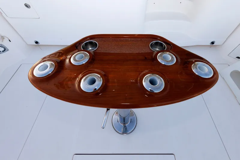 Slide: The Image of Polished wooden table with cup holders on a 2006 Cabo Yachts 40 Express. - 10
