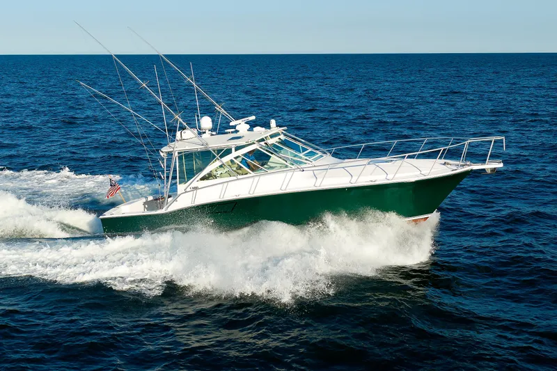 The Image of 2006 Cabo Yachts 40 Express cruising on open ocean waters. - 0