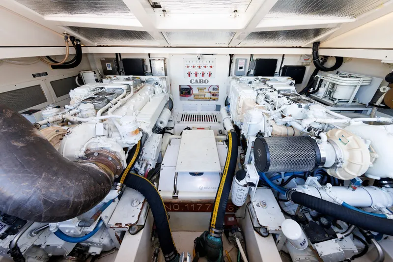 Slide: The Image of Engine room of a 2006 Cabo Yachts 40 Express, showcasing dual engines and mechanical systems. - 45