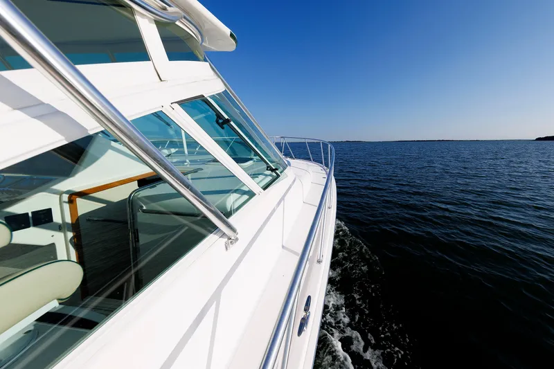 Slide: The Image of 2006 Cabo Yachts 40 Express cruising on open water under clear blue sky. - 42