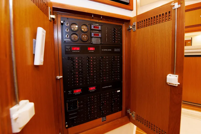 Slide: The Image of Electrical control panel inside a 2006 Cabo Yachts 40 Express, featuring gauges and switches. - 59