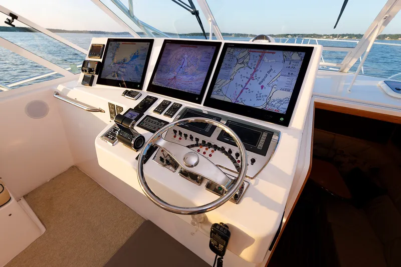 Slide: The Image of Helm of 2006 Cabo Yachts 40 Express with advanced navigation displays and controls. - 20