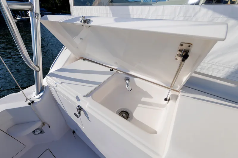 Slide: The Image of Open storage compartment with sink on 2006 Cabo Yachts 40 Express boat. - 11